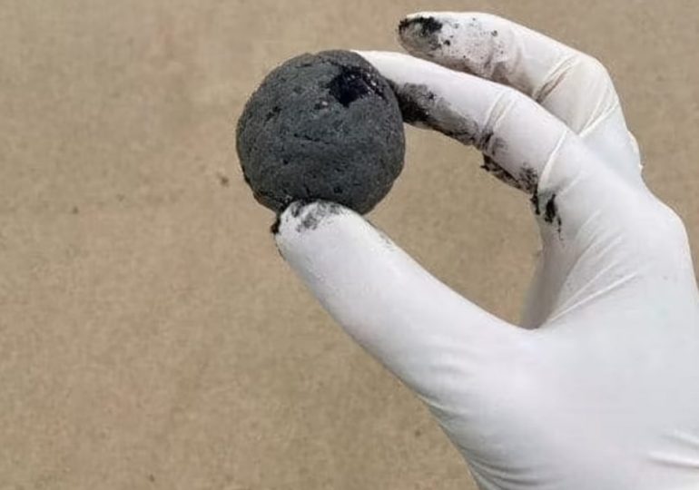 Thousands of mysterious black balls that smell ‘worse than ANYTHING’ wash up on iconic beaches – and no one knows why