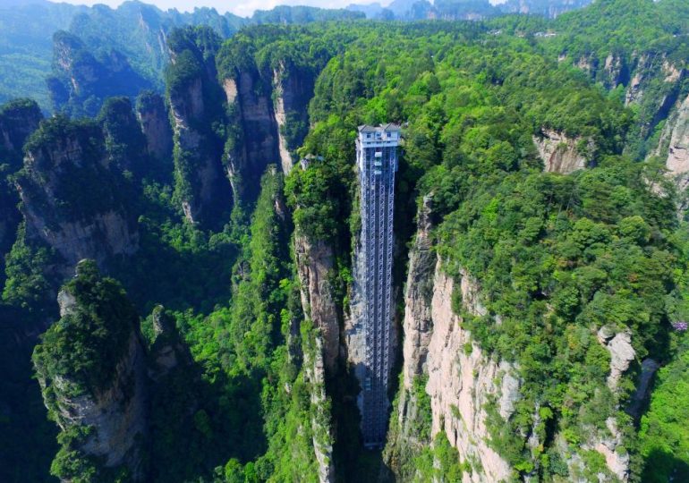 Vid goes inside the world’s tallest AND fastest elevator scaling mountain…& glass walls mean it’s not for faint-hearted