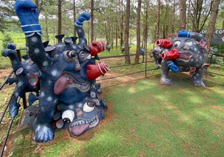 Inside the Covid THEME PARK as ghoulish fairground with giant viruses & creepy pandemic clock commemorates outbreak