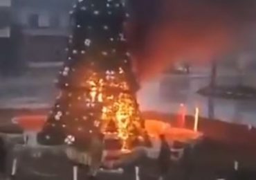 Moment Christmas tree is BURNED DOWN during Islamist protests in Syria amid fears for Christians after fall of Assad