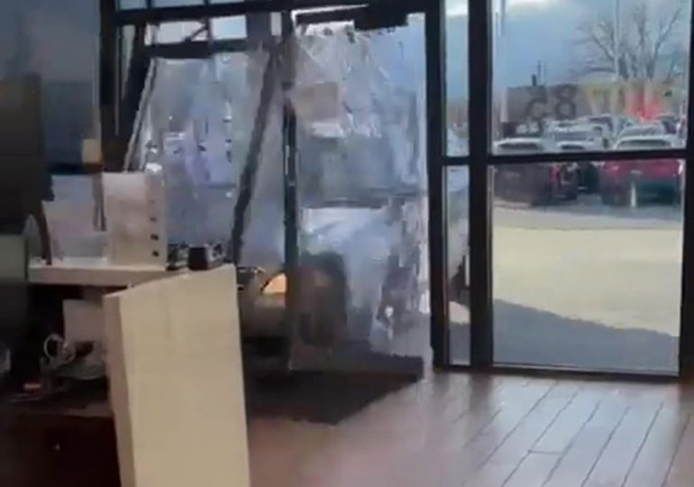 Watch moment raging driver smashes brand new car through dealership window while furiously demanding a refund