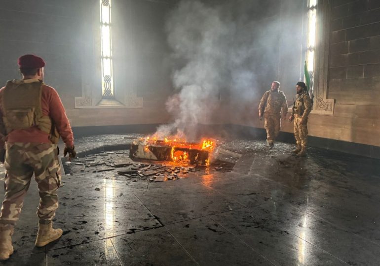 Watch moment cheering Syrian rebels burn COFFIN of Assad’s brutal father who slaughtered 40,000 civilians in massacre