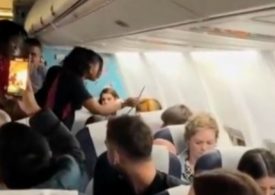 Moment female plane passenger throws her drink at stewardess before tossing her wig and attacking other travellers