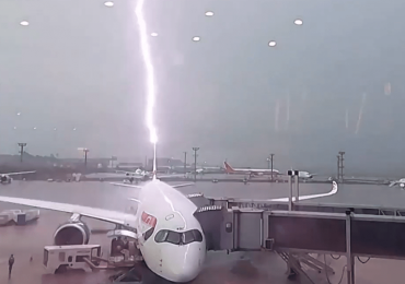 Watch as British Airways plane is struck by lightning & cars are swept away as devastating floods wreak havoc in Brazil