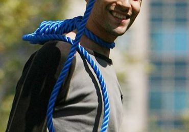 Incredible photo showing Iranian prisoner grinning moments before he was executed resurfaces after two judges shot dead