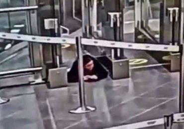 Watch moment woman crawls under airport security barrier before sneaking onto PLANE completely unnoticed