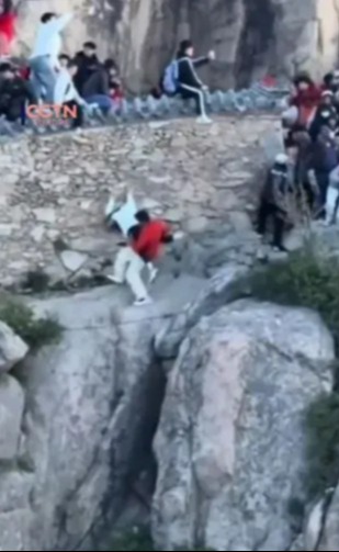 Watch shock moment couple cheat death as they fall off 5,000ft mountain while taking risky shortcut to avoid queue