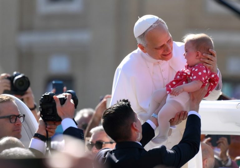 Pope Leo holds baby & waves to crowds in St Peter’s Square as world leaders gather for Pontiff’s inauguration mass