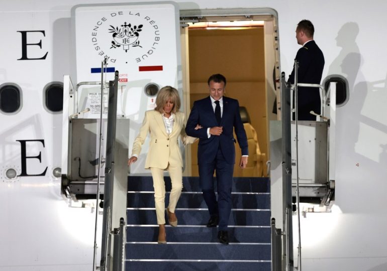 Moment Macron tries to laugh off ‘disturbing’ Brigitte slap in mocking wave as he steps off plane arm in arm with wife