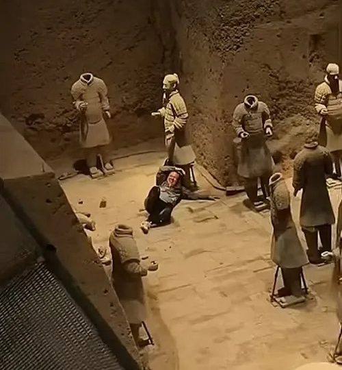 Shock moment tourist jumps railing and plunges 18ft into Terracotta Army pit before smashing two priceless statues