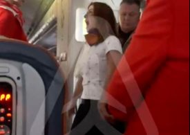 Wild moment furious female plane passenger has mid-air meltdown demanding business class upgrade