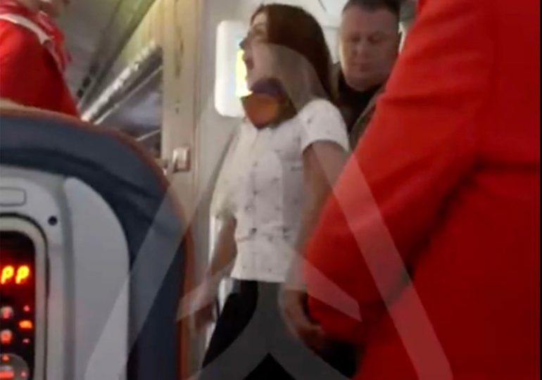 Wild moment furious female plane passenger has mid-air meltdown demanding business class upgrade