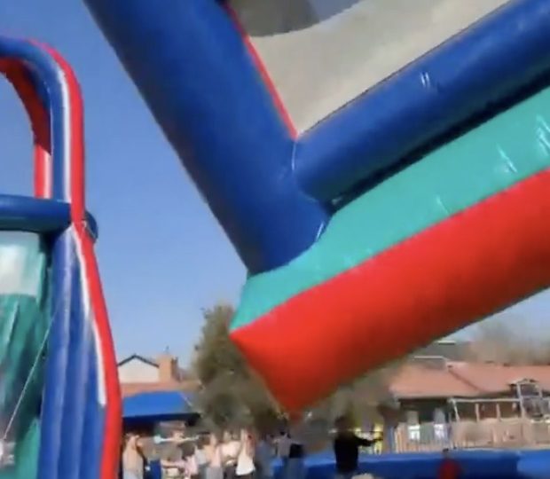 Terrifying moment bouncy castle takes off in freak wind flying 40ft into air sending children plunging back to earth