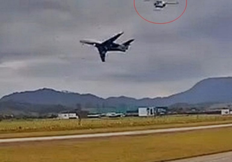 Harrowing moment plane comes terrifyingly close to helicopter as it takes off at airport