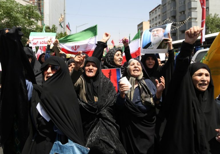 Iranians BURN US & Israel flags and chant ‘we want to DIE for Ayatollah’ as thousands join ‘death to the West’ protests