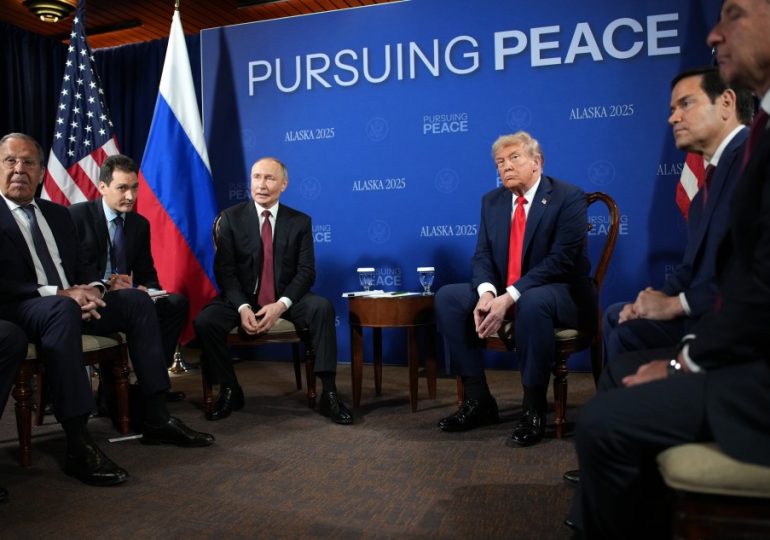 Moment Trump and Putin’s photocall erupts into CHAOS as smirking Vlad tries to shout over journalists before peace talks