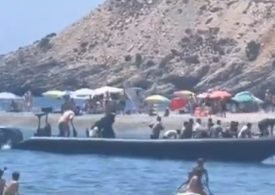 Watch moment migrant boat arrives on Spain hols beach before they are chased & tackled by angry locals