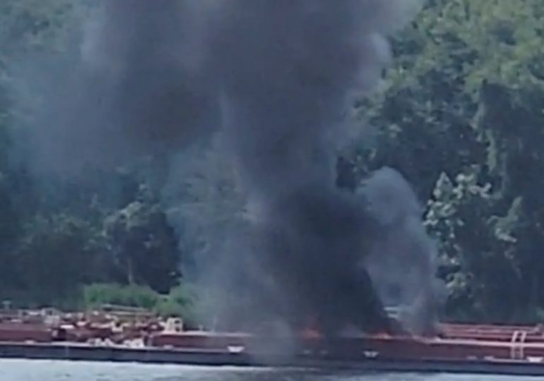 Helicopter crashes into barge killing two after hitting powerlines as burned-out wreck left on boat