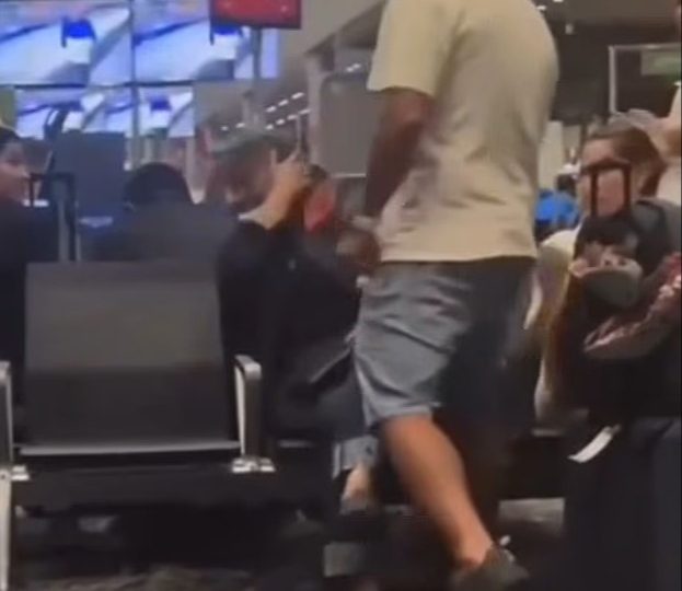 Shock footage shows passenger slap woman for refusing to give up seat at airport sparking furious row