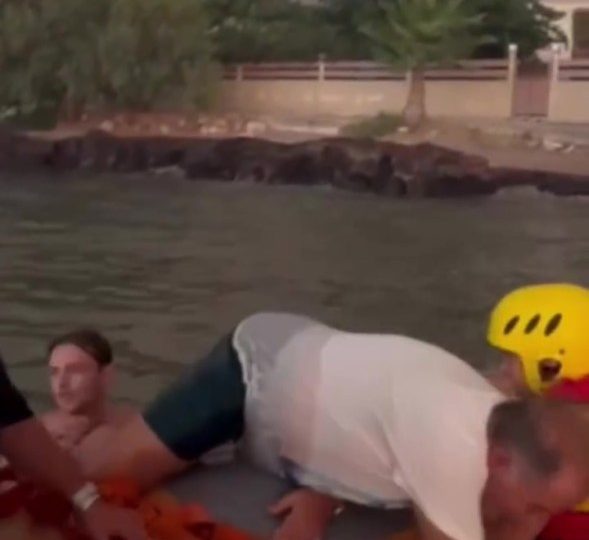 Horror moment desperate families run into the SEA to flee wildfires on holiday island as deadly blazes rip through towns