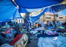 Migrants ‘urinated on’ after hundreds protest & sleep under tarpaulins outside Paris’ iconic town hall