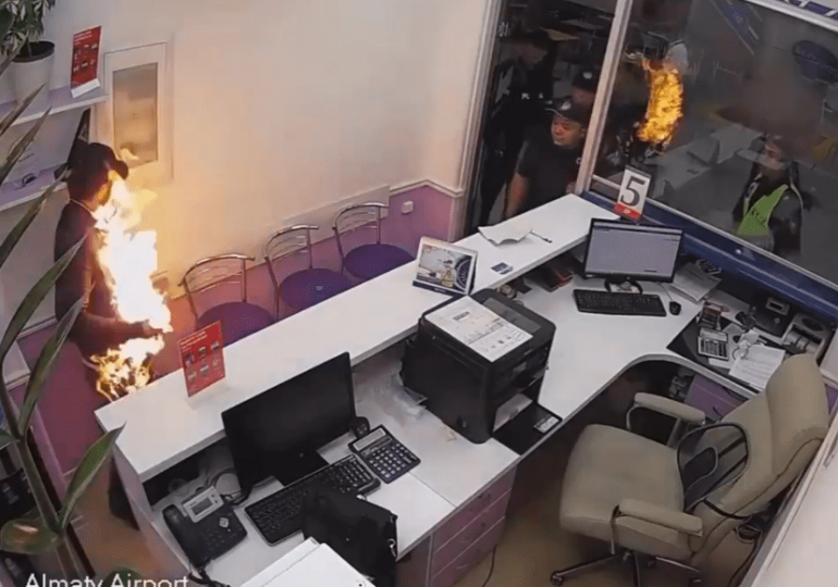 Horror moment man sets himself on FIRE at busy airport in front of screaming travellers after ‘missing his flight’