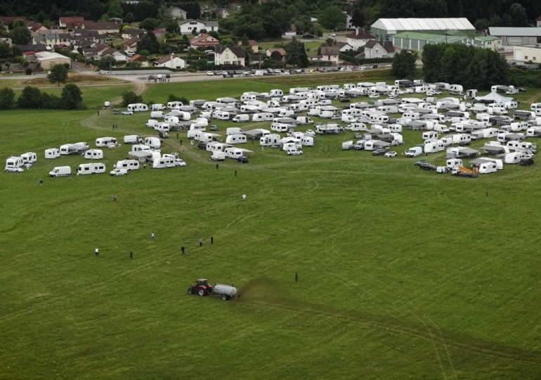 Moment furious French farmers use tractors to spray hordes of squatters with manure in drastic bid to get them off land