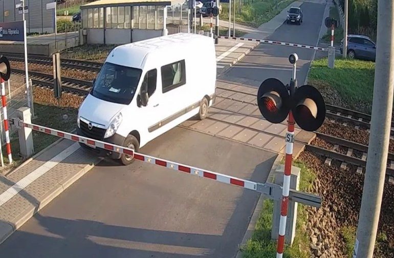 Watch moment idiot driver gets van SMASHED by train after trying to skip barriers at level crossing