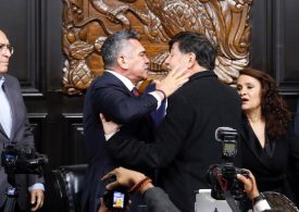 Brawl in Mexican parliament sees lawmakers shove each other and photographer pushed over as row breaks out over cartels