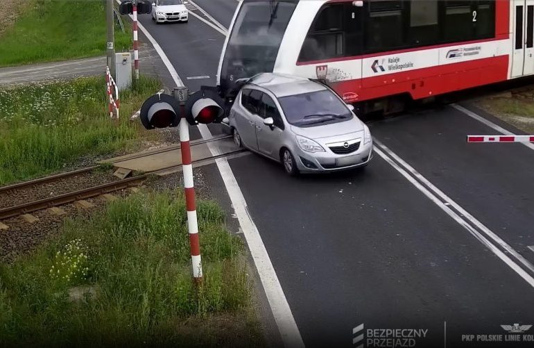 Shocking moment driver smashes through barrier & stops on level crossing before being wiped out by train