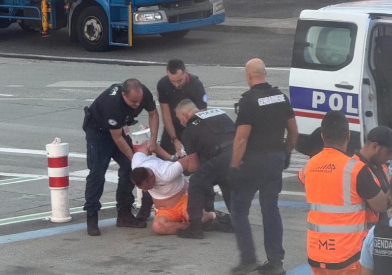 Moment drunk man is dragged off plane after trying to open door mid-air and brawling with other passengers