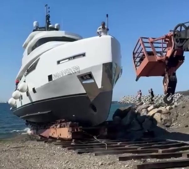 Horror moment luxury yacht capsizes and SINKS moments after it takes to water for maiden voyage off Brit holiday hotspot