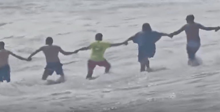 Terrifying moment human chain saves boy, 6, from being dragged out to his death by currents off Spanish ‘red flag’ beach