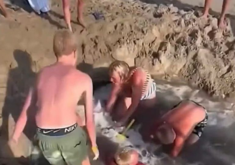 Heart-stopping moment kids get trapped in sinkhole on beach as panicked boys scream ‘get the lifeguard’