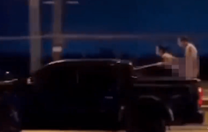 Shocking moment naked Russian couple romp while STANDING in the back of a speeding truck for stupid social media stunt