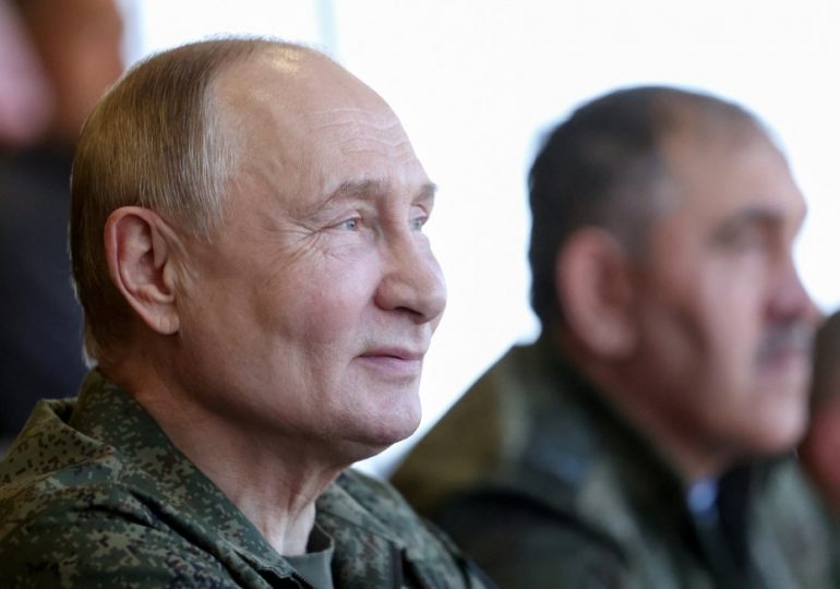 Putin dons military fatigues in war games 500 miles from the frontline in a show of strength to the West
