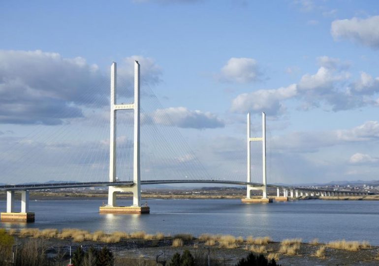 Two-mile ‘Bridge to Nowhere’ from China to North Korea abandoned so long that farmers dry crops on it could finally open