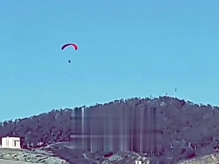 Shock moment migrant takes to the skies to PARAGLIDE into Europe over heavily fortified border