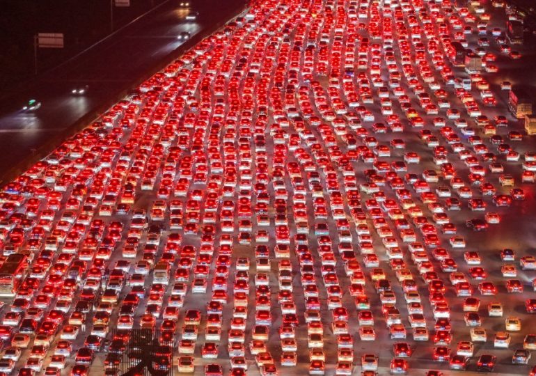Watch as miles-long traffic jam brings 36-lane highway in China to halt as 10MILLION cars hit roads for national holiday