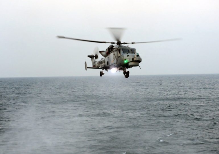 Royal Marine sniper takes out smuggling gang speedboat engine with single shot while flying BACKWARDS in chopper