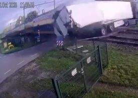 Train carrying 400 smashes into fruit lorry sending pears flying after bungling driver crosses tracks… but REVERSES back