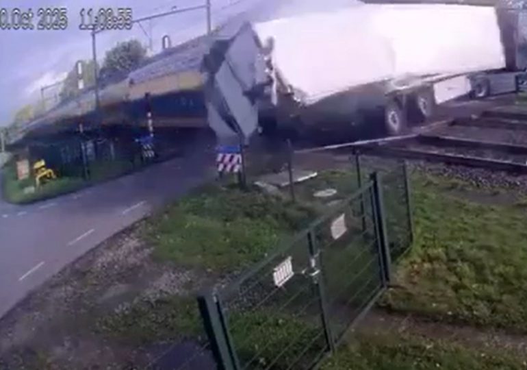 Train carrying 400 smashes into fruit lorry sending pears flying after bungling driver crosses tracks… but REVERSES back