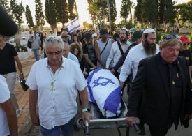 Israeli flag drapes coffin of hostage who died in Hamas captivity as his body is returned home