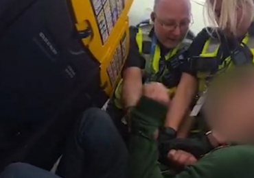 Shocking moment ‘drunk’ Brit passenger is grappled by cops on plane after ‘refusing to sit down during landing’