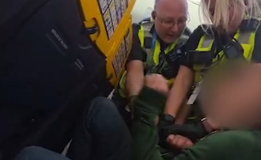 Shocking moment ‘drunk’ Brit passenger is grappled by cops on plane after ‘refusing to sit down during landing’