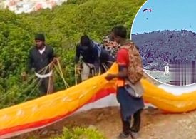 Shocking moment migrant tries to PARAGLIDE into Europe over fortified fence