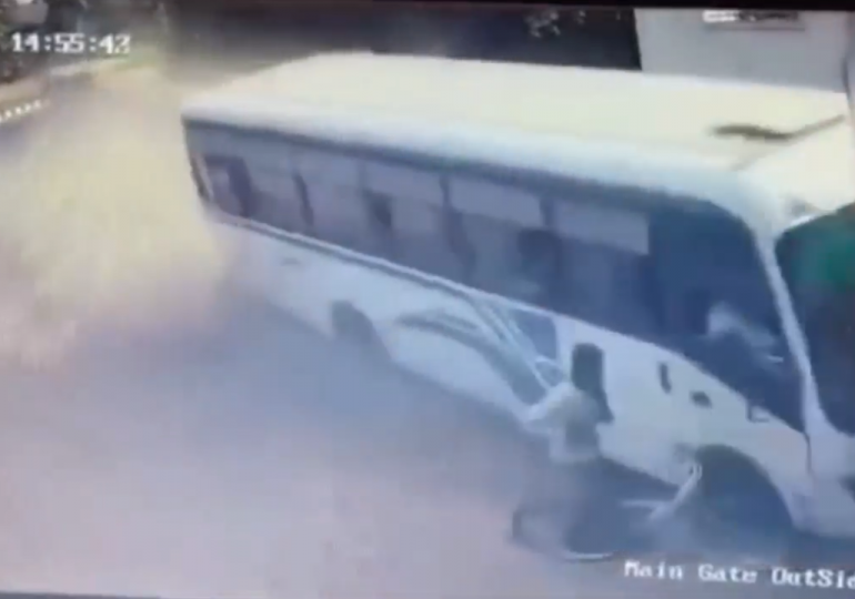 Horror moment out-of-control bus misses parked cyclist by just inches as it crashes into building