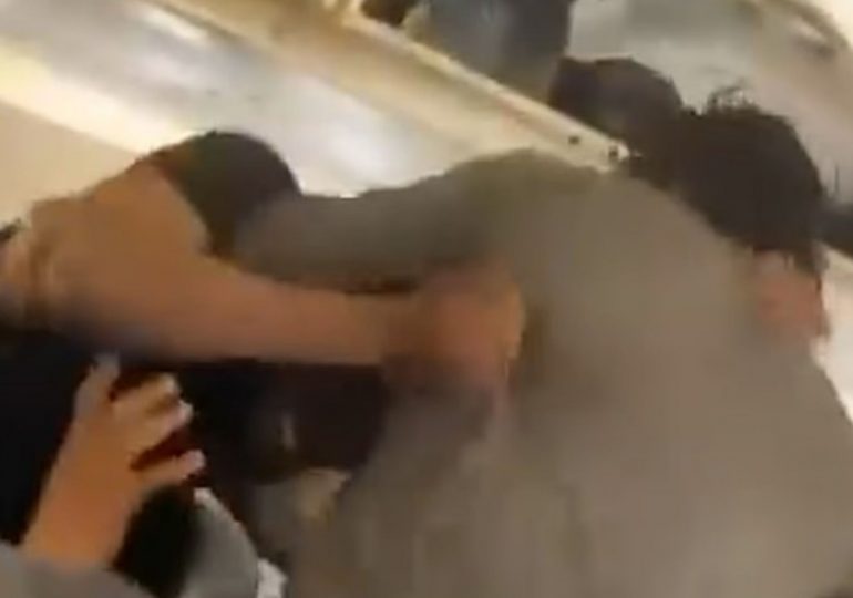 Shocking moment social media stars BRAWL in vicious punch up while boarding flight as passengers try to break it up