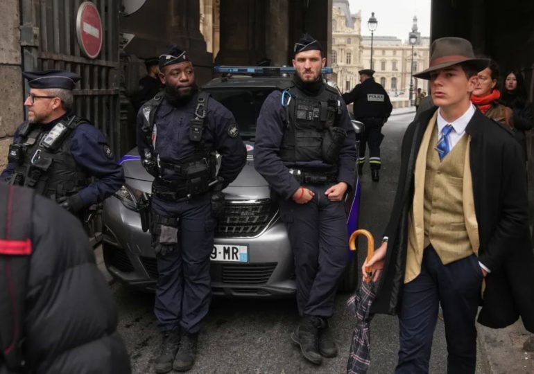 Mystery dapper ‘fedora man’ pictured at Louvre heist scene is finally unmasked – and reveals incredible coincidence