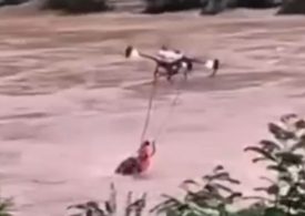 Watch incredible moment drone saves man from drowning in river as relentless flooding submerges houses and kills 55